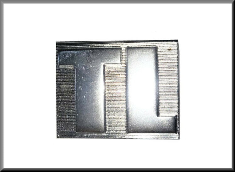 Embleem " – Renault 12 TL – OEM 7700545088 / 7700547107